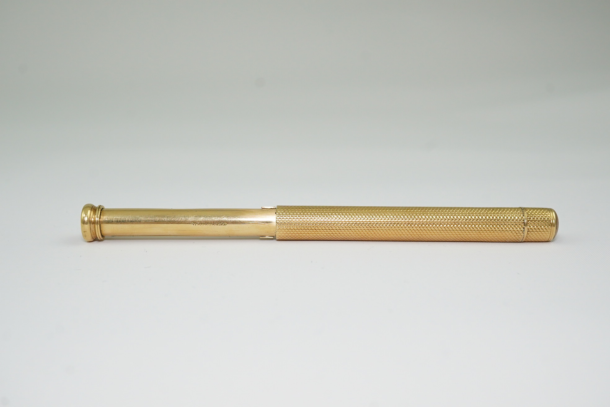 A late Victorian engine turned 18ct gold cased combination propelling pen and pencil, by Sampson Mordan & Co